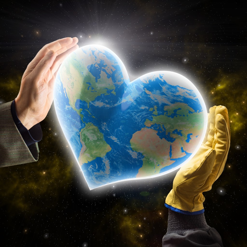 Hands of businessman and worker holding heart-shaped  Earth